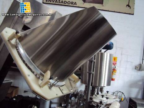 Alimentador e posicionador de tampas rotativo autom�tico